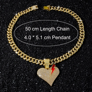 Detail of hip hop iced-out cuban link chain with 50cm length and red lightning heart pendant