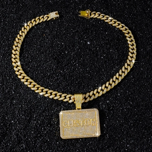 Close-up of golden Cuban link necklace with iced-out CUSTOM pendant and white CZ stones