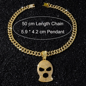 Detailed macro view of iced out balaclava pendant and 50cm golden Cuban link chain