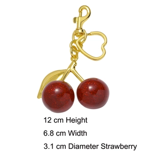 Detail view of red glitter cherry keychain with golden heart clasp and 12cm height dimensions