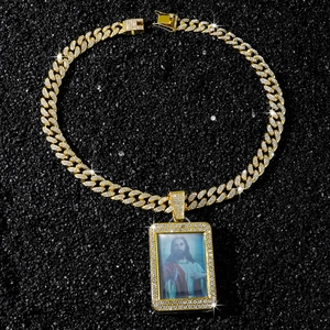 Detailed view of hip hop gold Cuban chain with iced-out square Jesus portrait pendant