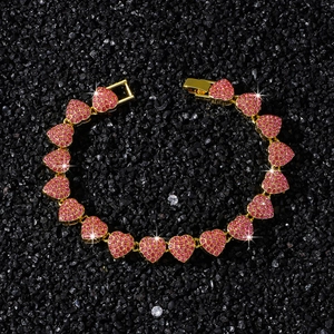 Pink heart-shaped link bracelet with sparkling rhinestones on black stone background