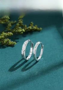 Detailed close-up of S925 sterling silver couple rings with elegant water wave texture