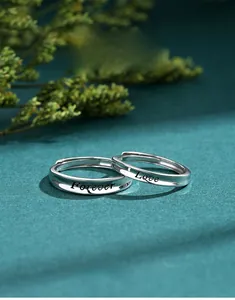 Detailed macro view of S925 sterling silver couple rings with Forever Love engraving