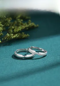 Macro shot of S925 sterling silver couple rings with micro-pave diamonds on velvet