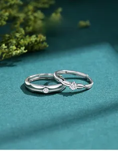 Macro shot of polished S925 silver couple rings with sparkling cubic zirconia inlay