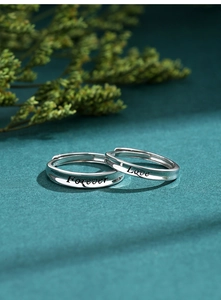 Detailed macro view of S925 sterling silver couple rings with Forever Love engraving