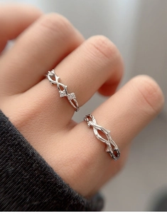 Detailed view of S925 silver couple rings featuring realistic branch texture and tiny diamonds