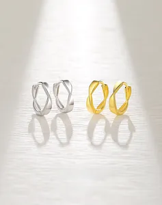 Detail of S925 silver Mobius earrings in gold and silver finish with elegant twisted design