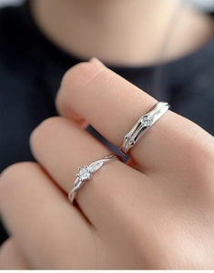 Close-up of S925 sterling silver couple rings set worn on hand for engagement
