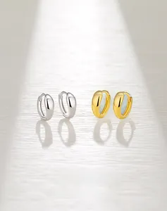 Detailed view of polished S925 sterling silver and gold wide hoop earrings set