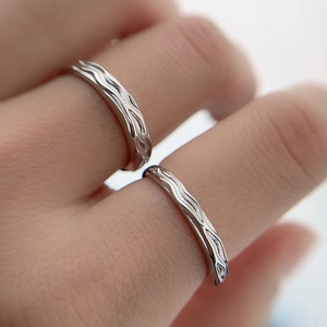 Minimalist S925 sterling silver couple rings with unique wavy textured design on hand