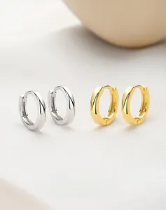 Macro view of gold and silver S925 sterling silver hoop earrings with textured finish