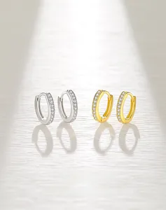 Macro shot of S925 silver hoop earrings in gold and silver with zircon pave setting