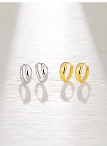 Polished S925 silver and gold water drop hoop earrings shown in a detailed studio close-up