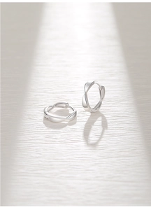 Detail view of S925 sterling silver Mobius earrings with twist design and shadow effects
