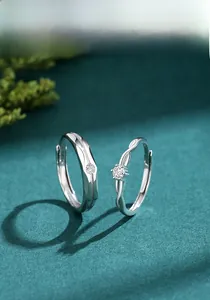 Macro shot of S925 sterling silver couple rings featuring a twisted band and six-prong diamond