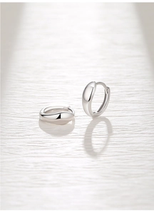 Detailed view of polished S925 sterling silver hoop earrings with a secure hinged closure
