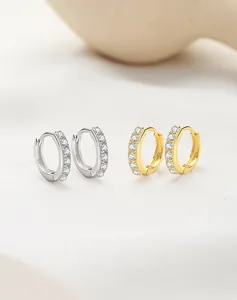 Detailed view of S925 silver and gold earrings with rows of sparkling white zircons