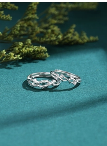 Detailed macro view of S925 silver couple rings with branch texture and zircon inlay