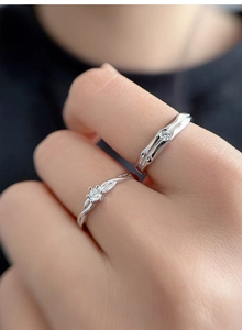 Close-up of S925 sterling silver couple rings with twisted diamond and textured bands