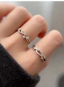 Macro shot of S925 silver couple rings featuring nature inspired branch textures and zircon