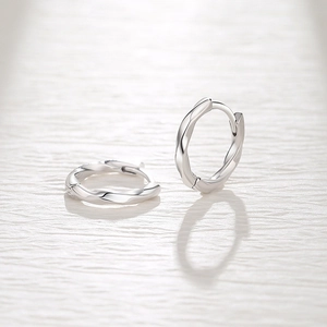 Polished S925 sterling silver Mobius hoop earrings with a minimalist twisted texture