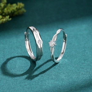Elegant S925 sterling silver couple rings set with sparkling diamonds on green background