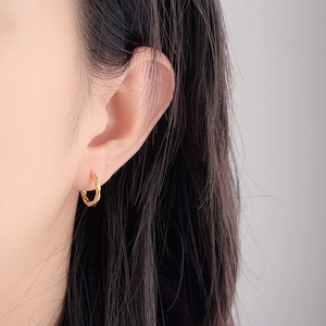 Polished gold Mobius S925 sterling silver hoop earrings with a twisted geometric design