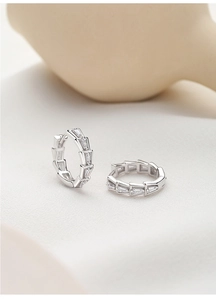 Detail showing trapezoid cut zircon inlay on silver tiered double loop hoop earrings