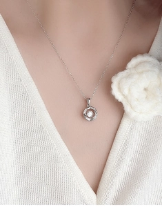 Close-up of S925 sterling silver beating heart necklace with zircon on a model