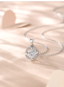 Macro detail of S925 silver beating heart pendant with round diamond in natural light