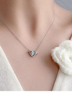 Close-up of S925 silver heart planet necklace with iridescent moonstone on a model