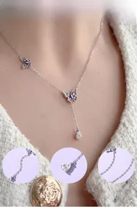 Detail of 925 silver butterfly necklace with cubic zirconia and purple enamel finish