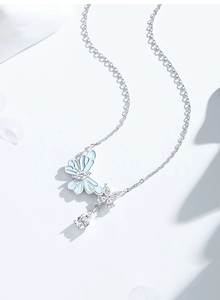 Detail of s925 silver butterfly necklace with blue enamel wing and teardrop stone