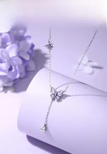Detail of S925 silver Y-necklace featuring purple enamel butterflies and a zircon drop