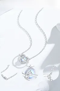 Detail of S925 silver heart necklace showing moonstone inlay and polished star ring finish