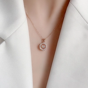 Rose gold S925 silver windmill necklace with dancing moissanite pendant on a model