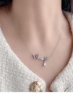 Detail of 925 silver necklace with lavender butterflies and a zircon teardrop pendant