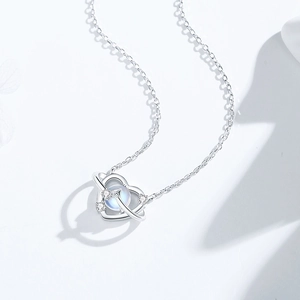 Elegant S925 silver heart planet necklace featuring moonstone and sparkling white crystals