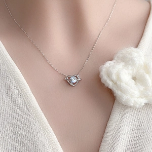 S925 silver heart necklace with moonstone pendant worn on neck with white sweater