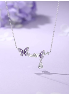 Detail of 925 silver butterfly necklace with purple enamel and zircon teardrop pendant