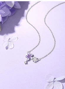 Detailed close-up of S925 silver necklace with purple enamel and sparkling flower charms