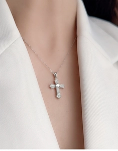 Close-up of S925 sterling silver cross pendant necklace with zircon on white suit