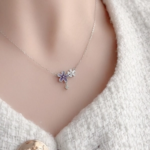 Elegant S925 sterling silver necklace with purple flower pendant on a model's neck
