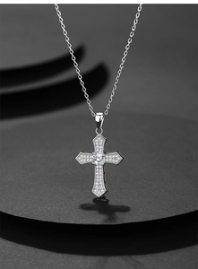 Close-up of S925 silver cross pendant with sparkling pavé zircons and a large center stone