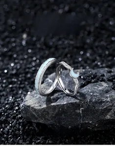 Detailed macro view of S925 silver couple rings featuring luminous moon and star patterns