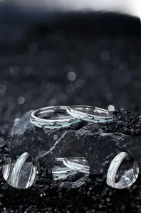 Detail of S925 sterling silver couple rings with luminous blue oil drip and mirror polish