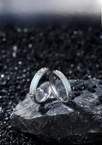Macro shot of S925 sterling silver couple rings with blue enamel glacier texture