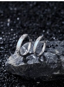 Macro shot of S925 sterling silver couple rings with glacier blue texture and inner engraving